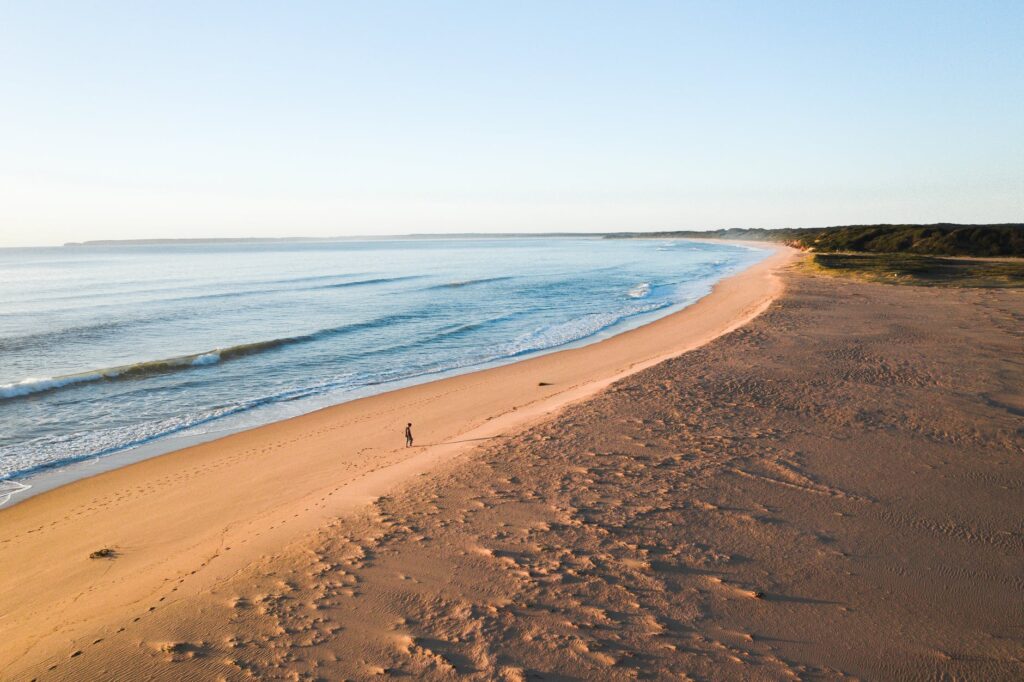 traveler walking near rippling sea